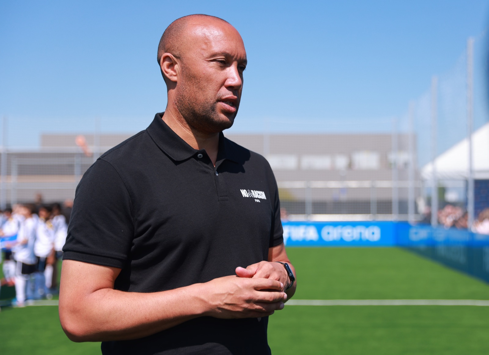 Mikaël Silvestre wearing FIFA's No Racism shirt pitchside at a FIFA Arena event