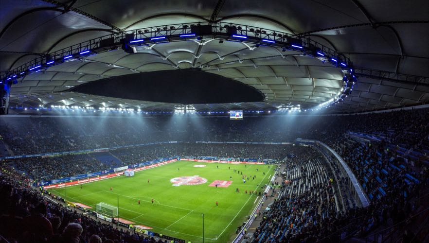 European football stadium under floodlights